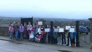 Protestors demonstrating against the use of a path at Llanbeblig graveyard