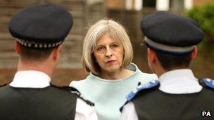 Theresa May and police officers