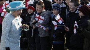 The Queen meeting children waving flags