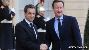 Nicolas Sarkozy greets David Cameron in Paris before meeting in December 2011