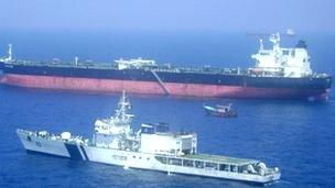 Indian warship alongside the Italian cargo vessel