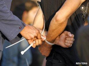 A protester is arrested in Manama (14 February 2012)