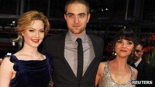 Cast members Robert Pattinson (C), Christina Ricci (R) and Holliday Grainger pose on the red carpet to promote the movie Bel Ami at the Berlinale International Film Festival in Berlin on Friday