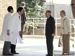 Emperor Akihito and Empress Michiko are greeted by doctors at the University of Tokyo hospital on 17 February 2012