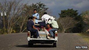 The coffin of one of the victims of a prison fire in Honduras is transported to a cemetery