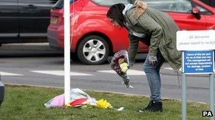 Woman lays flowers at Alvechurch School in Worcestershire