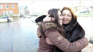 Spaniard Patricia Cigala says goodbye to her visiting mother at a bus stop in Munich