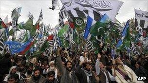 Activists of Pakistani Islamist groups and political parties hold their party flags as they shout slogans during an anti-US protest rally in Islamabad on February 20, 2012.