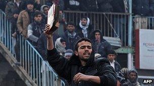 Half-burnt Koran held during protest outside Bagram Airbase