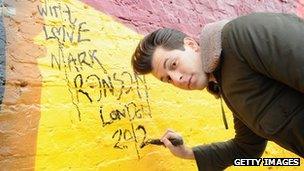 Mark Ronson signing the "Beat Wall" near the Olympic Stadium in London