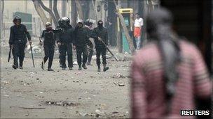 Protester hides from riot police on street close to Cairo's interior ministry on 6 Feb