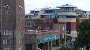 The clock tower of the newly listed building, with the new police station in the background