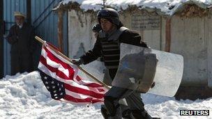 Afghan soldier runs with American flag