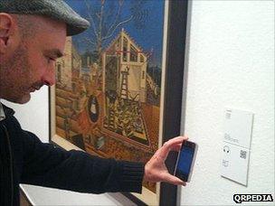 A man scans a QRpedia code