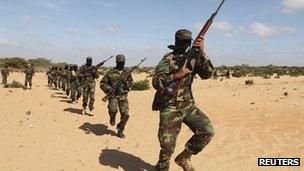 Members of Somalia's al-Shabab militant group parade during a demonstration to announce their integration with al-Qaeda south of the capital, Mogadishu, on 13 February 2012