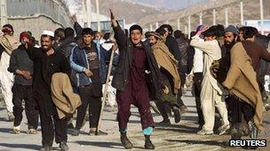 Afghan protesters gesture towards police in Kabul on 24 February