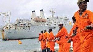 Workers haul part of a fibre optic cable onto the shore at the Kenyan port town of Mombasa on 12 June 2009. An undersea fibre optic cable bringing broadband Internet connectivity to east Africa.