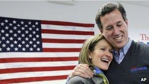 Republican presidential candidate, former Pennsylvania Sen. Rick Santorum hugs his wife, Karen during a stop at his campaign field office