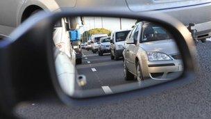 Reflection of traffic in a car wing-mirror