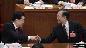 China's Premier Wen Jiabao, right, shakes hands with President Hu Jintao after the opening ceremony of the National People"s Congress (NPC) at the Great Hall of the People in Beijing 5 March, 2012