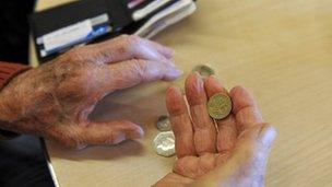 A pensioner holding some coins