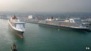 Queen Mary 2 steams past the other two liners in the Cunard fleet at Southampton Docks