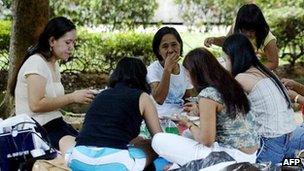 File picture of maids in Singapore on a day off in the park 27 July 2003