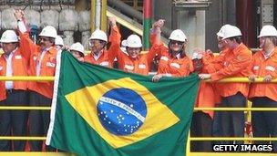 Brazilian President Dilma Rousseff joins workers to celebrate the construction of a new oil rig