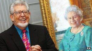 Rolf Harris with his portrait of the Queen