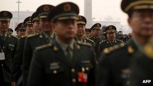 People's Liberation Army (PLA) soldiers arrive at the Great Hall of the People in Tiananmen square for the National People's Congress (NPC) in Beijing on 5 March, 2012