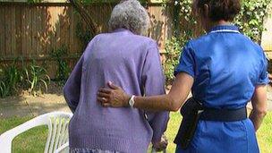 Nurse helping elderly woman