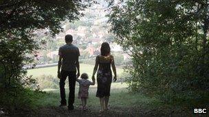 Family walking through trees