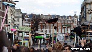 Broom wielding residents gather to clean up after August riots in England