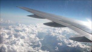 The view from above the clouds from the left side of an unidentified aeroplane