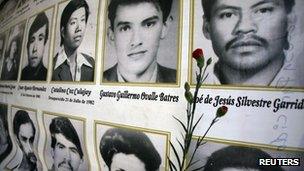 A red carnation is placed next to the photographs of people killed in Guatemala's 36-year civil war, before a ceremony to commemorate the National Day of Dignity in Guatemala City 25 February 2012.