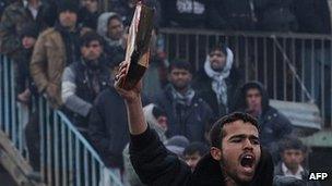 Man brandishing half burned Koran