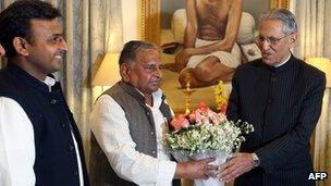 Akhilesh Yadav (left), Mulayam Singh Yadav (centre) and Uttar Pradesh Governor BL Joshi