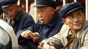 Older men wait at Guangzhou railway station