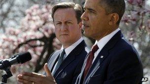 David Cameron looks on as Barack Obama speaks during a press conference 14 March 2012