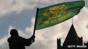 Man waving flag with Irish sentiment