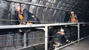 Workers on manriding conveyor at Daw Mill