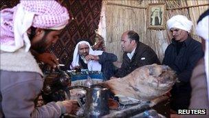 Bedouin men sit at a tribal meeting in North Sinai