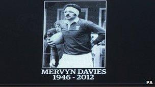 Image of Mervyn Davies on the big screen during the minute's silence