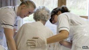 Nurses with elderly patient