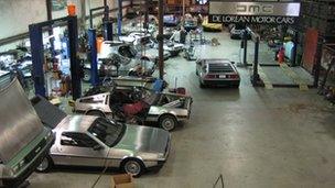 DeLorean Motor Company workshop with DMC-12s in various states of repair