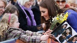 Duchess of Cambridge talks to a young girl during a visit to Each, Ipswich