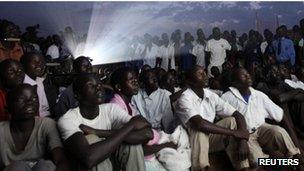 Residents watch the premiere of "Kony 2012", a 30-minute YouTube film created by the nonprofit group Invisible Children, in Lira district located 376 km (234 miles) north of Uganda"s capital Kampala March 13, 2012.