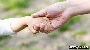 Child holding an adult's hand