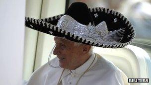 Pope Benedict XVI wears a traditional Mexican hat while driving through the crowd in Silao