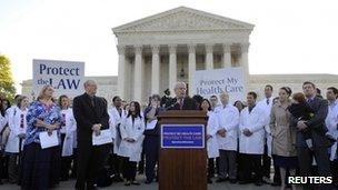 Doctors wearing white coats rally outside the US Supreme Court, 26 March 2012